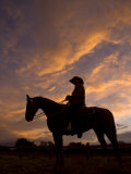 Silhouetted Cowboy Actor on Horseback on an Old Western Movie Set Lámina fotográfica por Ralph Lee Hopkins