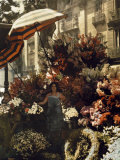 Woman Stands in Front of Her Flower Stand on the Rambla Photographie par Gervais Courtellemont