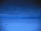 Commercial Boat Off of Ireland under a Stormy and Threatening Sky Photographie par Paul Nicklen