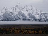 Clouds Hover Above a Valley in Grand Teton National Park Photographie par Jodi Cobb