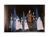 Penitents March in a Malaga Street Procession During Holy Week Photographie par Gervais Courtellemont