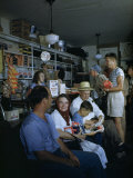 Townsfolk Linger and Shoppers Shop at a General Store Photographie par Walter Meayers Edwards