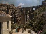 Boy Sits in Front of the Bridge Which Connects Ronda Photographie par Gervais Courtellemont
