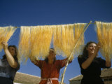 Women Hang and Comb Freshly Washed Silk Moth Gut Photographie par Luis Marden