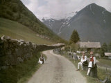 Norwegian Girls Seated Along a Dirt Road, Lined with a Stone Fence Photographic Print by Gustav Heurlin