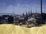Large Pile of Sulfur Dominates a View of a Chemical Plant Photographie par Robert Sisson
