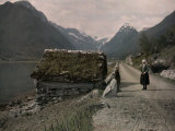 Two People Stand on a Dirt Road Along a Fjord Leading to Mundal Photographic Print by Gustav Heurlin