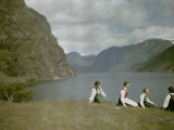 Norwegian Women in Traditional Dress Relaxing in a Scenic Fjordland Photographic Print by Gustav Heurlin