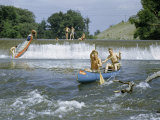 Men Paddle into Fast Waters While Others Slide Canoe Down Waterfall Photographie par Walter Meayers Edwards