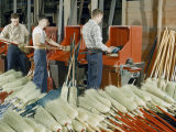 Men Work at Revolving Cylinders That Clean and Comb Broom Fibers Photographie par Willard Culver
