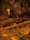 Man Peers Out from an Ancient Tomb in Falerii Novi, Italy Impressão fotográfica por O. Louis Mazzatenta