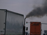 Diesel Truck Belching Exhaust from it's Smokestack at a Truckstop Photographic Print by Mark Thiessen