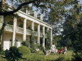 Servant Brings Tea to Women Seated on Lawn Outside Plantation House Photographic Print by Justin Locke