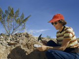 Woman Chips Rock Searching for Stones to Set in Jewelry Photographie par Willard Culver