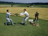 Men Pull on Turf of Combined Grasses to Show its Strength Photographie par Jack Fletcher