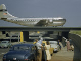 Sightseers Park to Watch a Stratocruiser Taxi across an Underpass Photographie par B. Anthony Stewart
