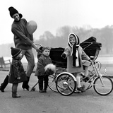 Jenny Boyd in Light Pants and Boots with Children, 1960s Giclee Print by John French