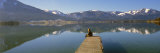 Woman Sitting on a Pier at Lakeside, Wolfgangsee, St. Wolfgang, Salzkammergut, Upper Austria Photographic Print by Panoramic Images 