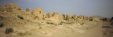 Ruins of Buildings in a Desert, Jiaohe Ruins, Turpan, Xinjiang Province, China Lámina fotográfica por Panoramic Images Ruins of Buildings in a Desert, Jiaohe Ruins, Turpan, Xinjiang Province, China Lámina fotográfica por Panoramic Images