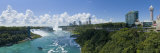 Waterfall in River with New York Skyline in Background, Niagara Falls, Ontario, Canada Photographic Print by Panoramic Images 