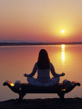 Yoga on a Saddle Bench Watching the Sun Go Down across the Zambesi River, Zambia Photographic Print by John Warburton-lee