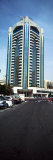 Cars Parked at the Roadside in Front of a Building, Dubai Creek Tower, Dubai, United Arab Emirates Photographic Print by Panoramic Images 