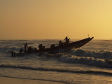 Fishermen Launch their Boat into the Atlantic Ocean at Sunset Photographic Print by Amar Grover