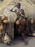 Datoga Woman Relaxes Outside Her Thatched House, Tanzania Photographic Print by Nigel Pavitt