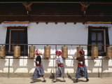 Mosu Women Push Prayer Wheels at a Small Monastery on Liwubi Island, China Photographic Print by Amar Grover