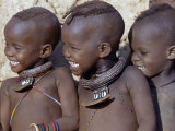 Three Happy Himba Children Enjoy Watching a Dance, Namibia Fotografie-Druck von Nigel Pavitt