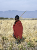 Young Boy of the Datoga Tribe Crosses the Plains East of Lake Manyara in Northern Tanzania Fotografie-Druck von Nigel Pavitt