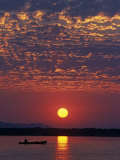 Lower Zambesi National Park, Canoeing on the Zambezi River at Sun Rise under a Mackerel Sky, Zambia Photographic Print by John Warburton-lee