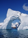Grandidier Channel, Tourists Zodiac Cruising by Arched Iceberg Near Booth Island, Antarctica Lámina fotográfica por Allan White