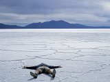 Tourist on Salt Crust of Salar De Uyuni, Emphasising Scale of Largest Salt Flat in World, Bolivia Photographic Print by John Warburton-lee