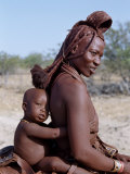 Himba Mother and Child Ride Home on Donkey, Bodies Gleaming from a Red Ochre Mixture, Namibia Photographic Print by Nigel Pavitt