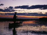 Zambia Game Scout Poling Mokorro Along Lukulu River at Sunset Photographic Print by John Warburton-lee