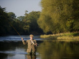 Trout Fisherman Casting to a Fish on the River Dee, Wrexham, Wales Photographic Print by John Warburton-lee