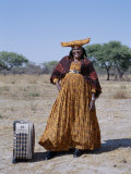 Smartly Dressed Herero Woman Waits for a Bus, Namibia Photographic Print by Nigel Pavitt