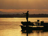 Lower Zambezi National Park, Fly Fishing for Tiger Fish from a Barge on the Zambezi River at Dawn,  Photographic Print by John Warburton-lee