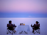 Tourists Enjoy Sundowners While Looking Out across the Endless Salt Crust of Salar De Uyuni Photographic Print by John Warburton-lee