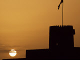 Silhouette of One of the Towers of Ras Al Hadd Castle at Sunset, Oman Photographic Print by John Warburton-lee
