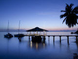 Seychelles, Praslin Island, Anse Bois De Rose, Pier at the Coco De Mer Hotel, Sunset Lámina fotográfica por Walter Bibikow