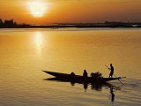 Mopti, at Sunset, a Boatman in a Pirogue Ferries Passengers across the Niger River to Mopti, Mali Photographic Print by Nigel Pavitt