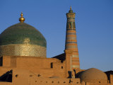 Minaret and Tiled Dome of a Mosque Rise Above the Old City of Khiva Photographic Print by Antonia Tozer