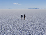 Two Tourists Walk across the Endless Salt Crust of Salar De Uyuni, the Largest Salt Flat in World Photographic Print by John Warburton-lee