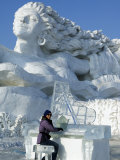 Harbin City, A Tourist Is Playing a Sculpted Ice Piano, Snow and Ice Festival, China Photographic Print by Christian Kober