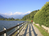Man Bikes Along Path at Lake's Edge, Lake Como, Italian Lakes, Lombardy, Italy, Europe Photographic Print by Vincenzo Lombardo