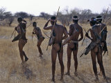 Bushmen or San Hunter-Gatherers Pause to Check a Distant Wild Animal in the Early Morning, Namibia Photographic Print by Nigel Pavitt
