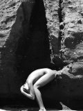 Nude Woman Crouching Between Crevice Photographic Print by Images Monsoon