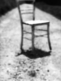 Empty Straight-Backed Chair in Spotlight Lámina fotográfica por Images Monsoon
